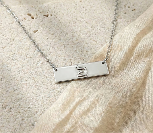 Sterling silver eternity bar necklace on stone background
