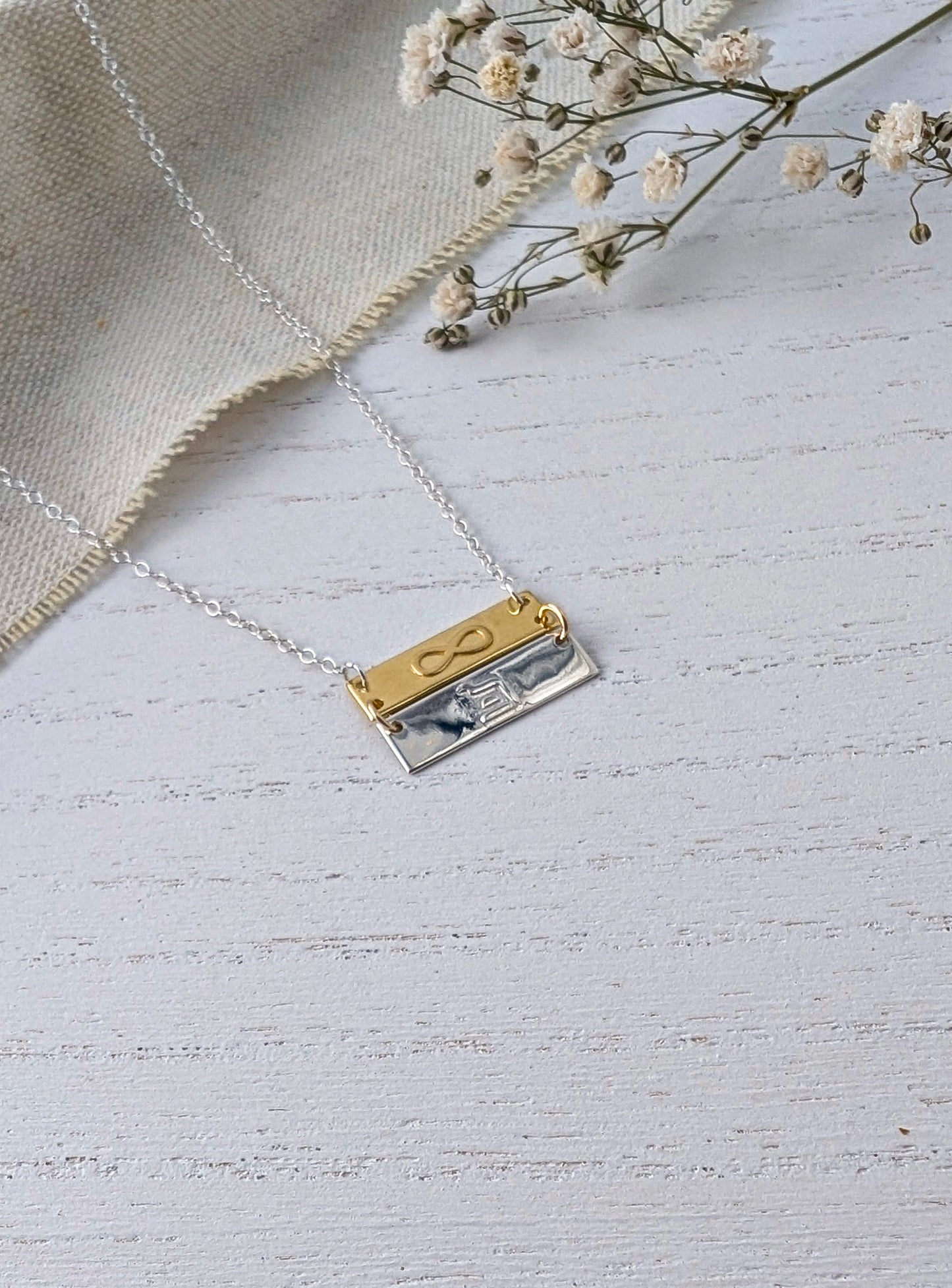 infinity eternity pendant necklace on wooden surface