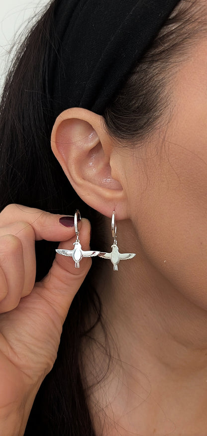 flacon earrings worn by woman