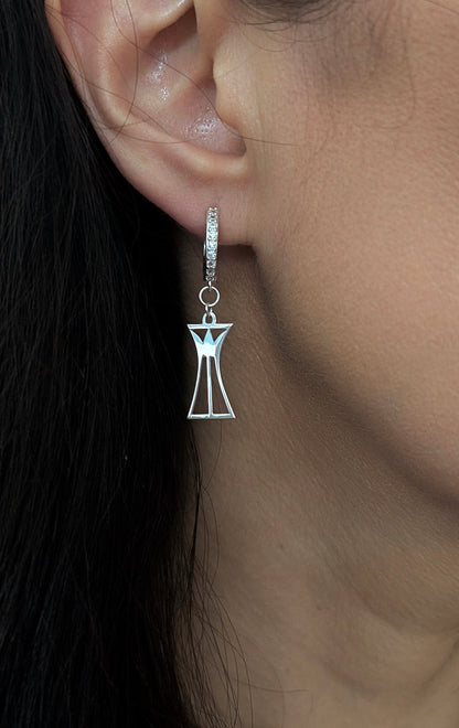 Silver lotus column earring worn by a woman with dark hair.