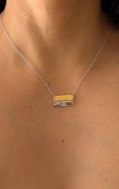 close up of infinity eternity double bar necklace on woman