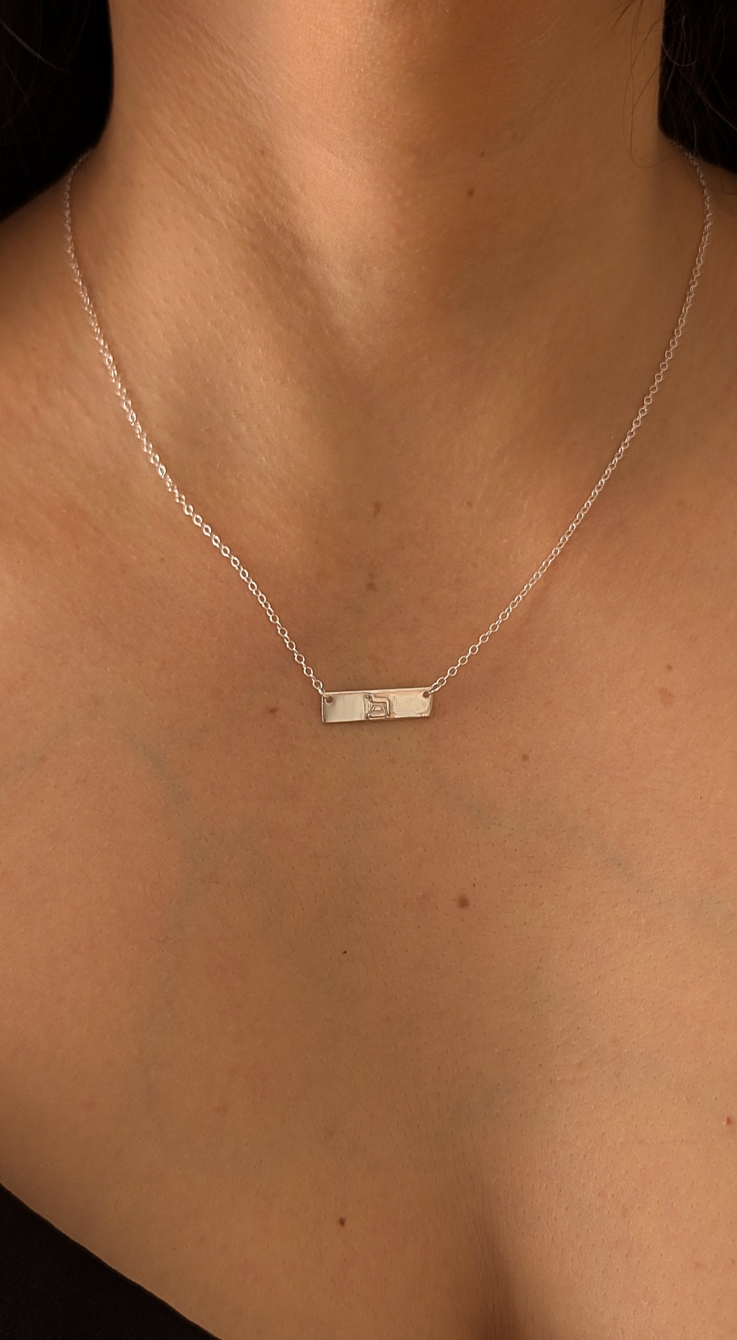 silver eternity necklace worn by woman