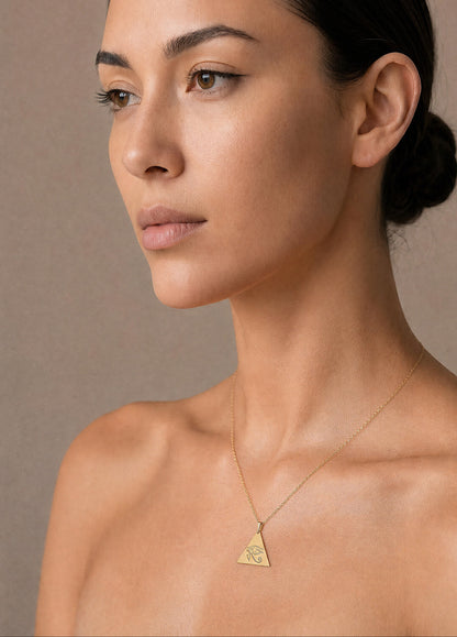 gold eye of horus necklace worn by woman