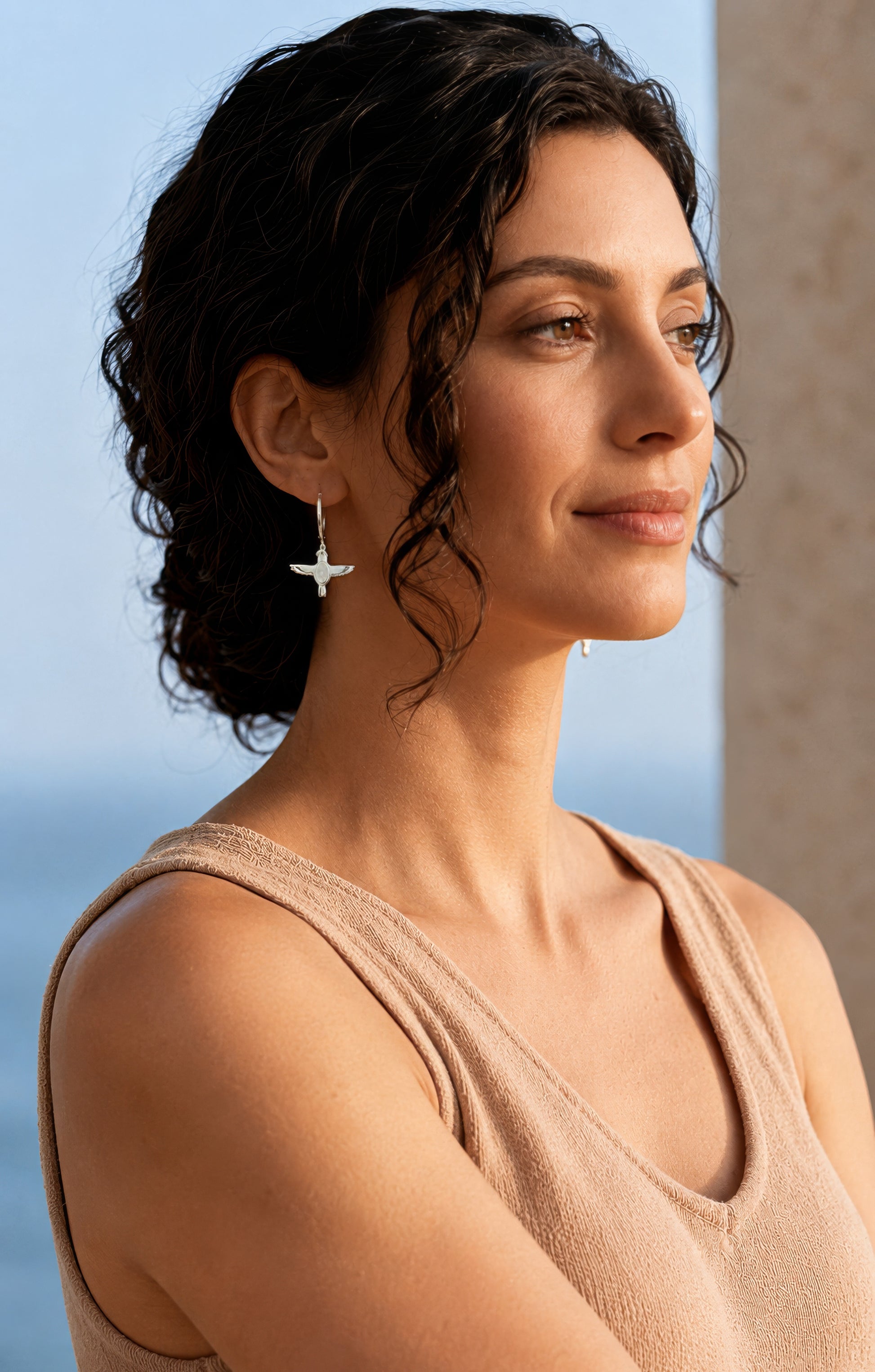 falcon earring worn by woman