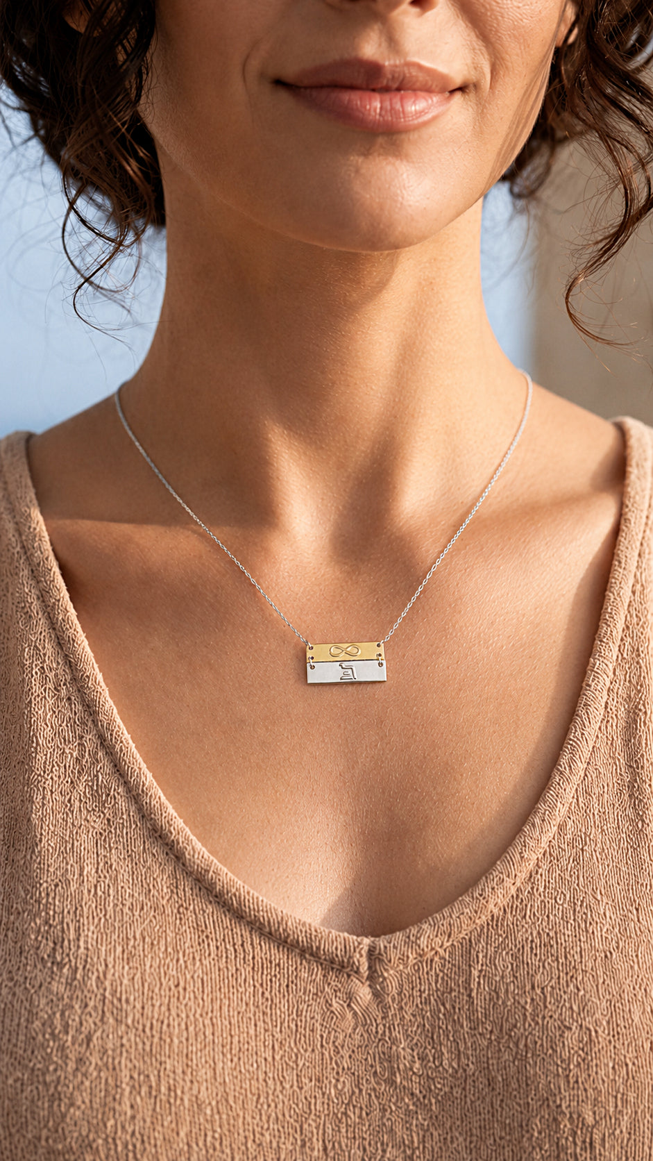 close up of eternity infinity necklace on woman
