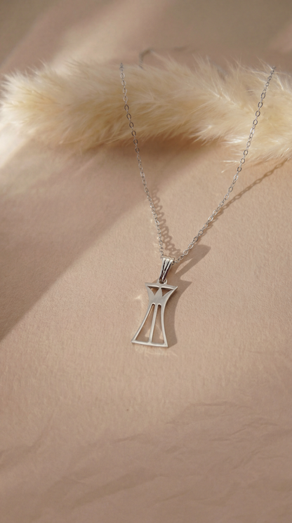 Silver lotus column necklace on a beige background
