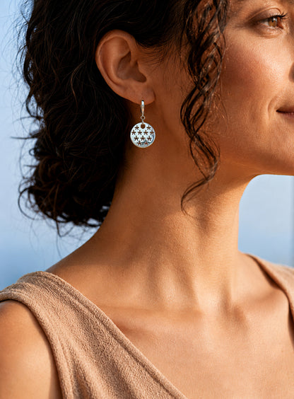 silver stars earring worn by woman