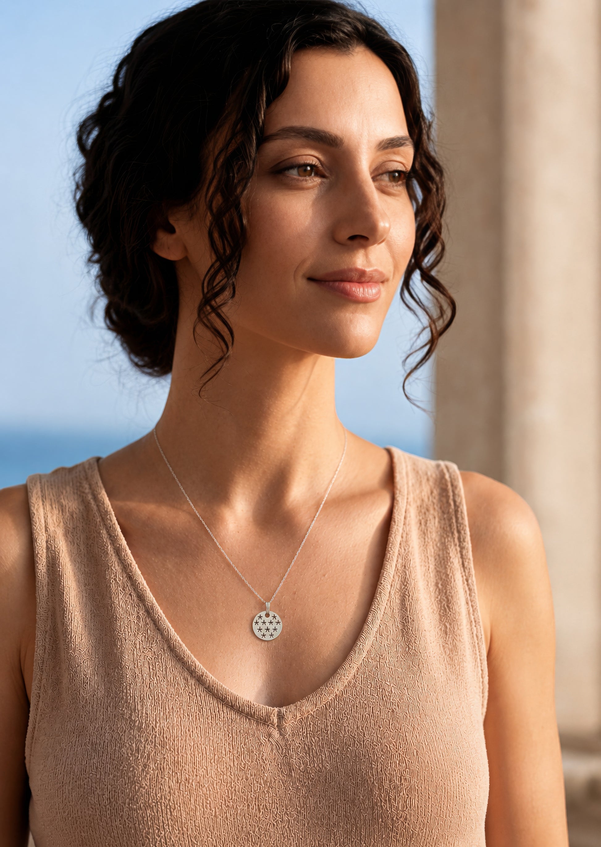 silver necklace with stars pendant worn by woman
